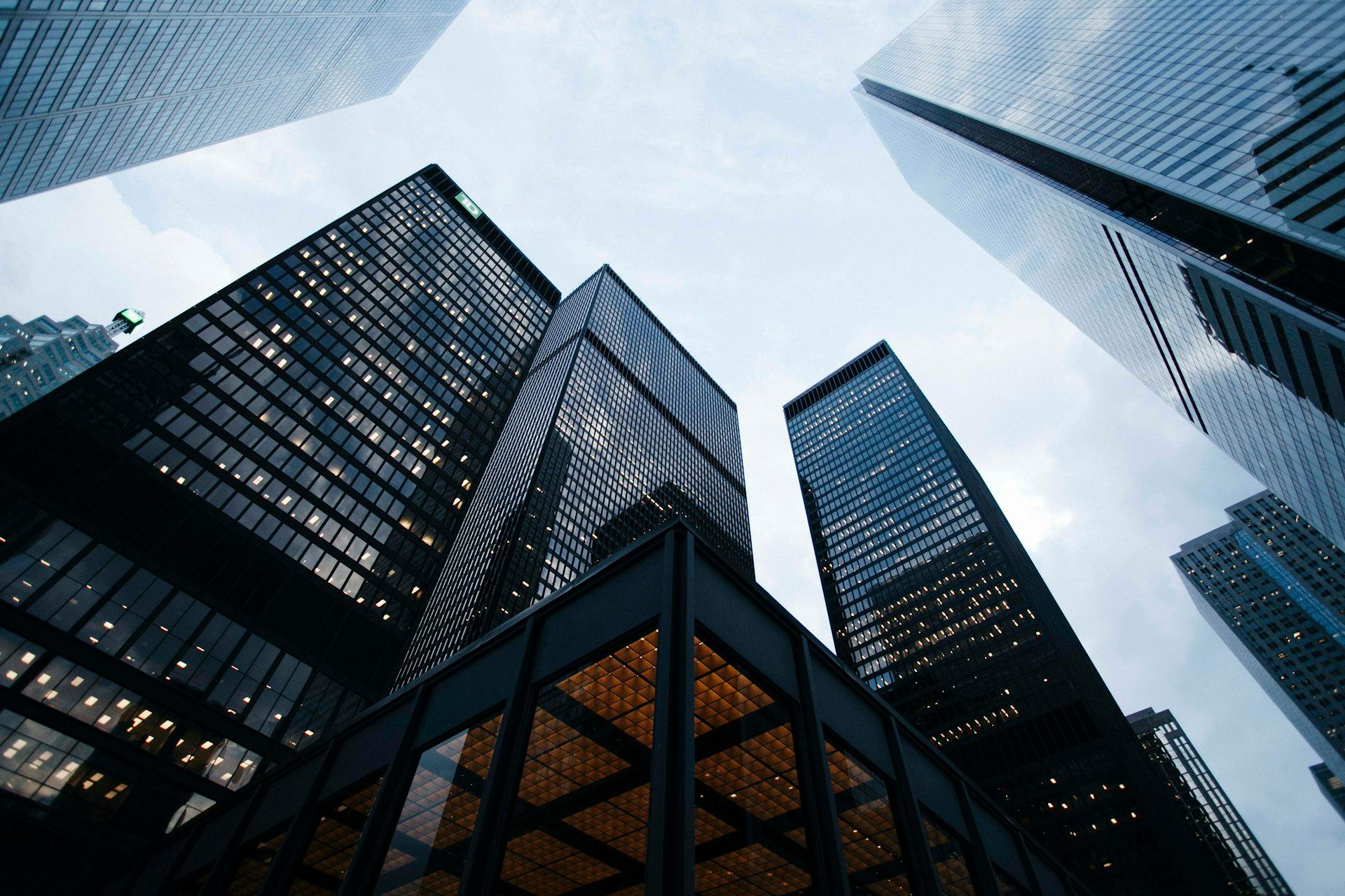Glass office towers seen from below.
