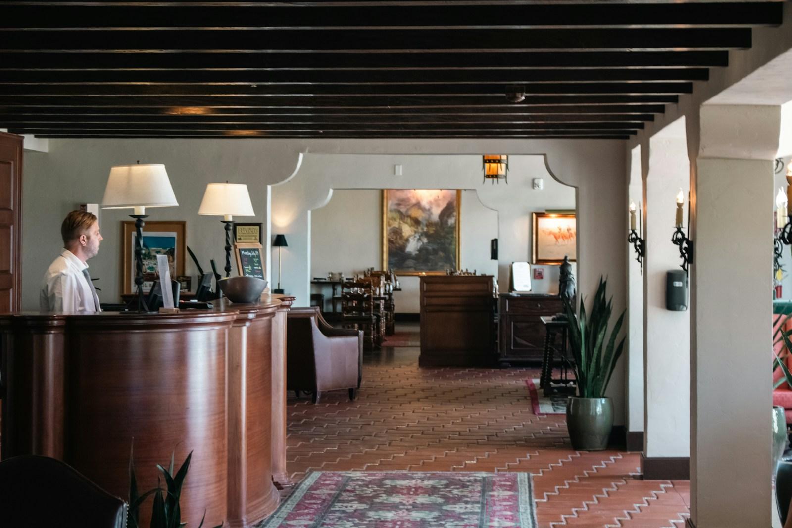 A hotel reception with staff at the desk