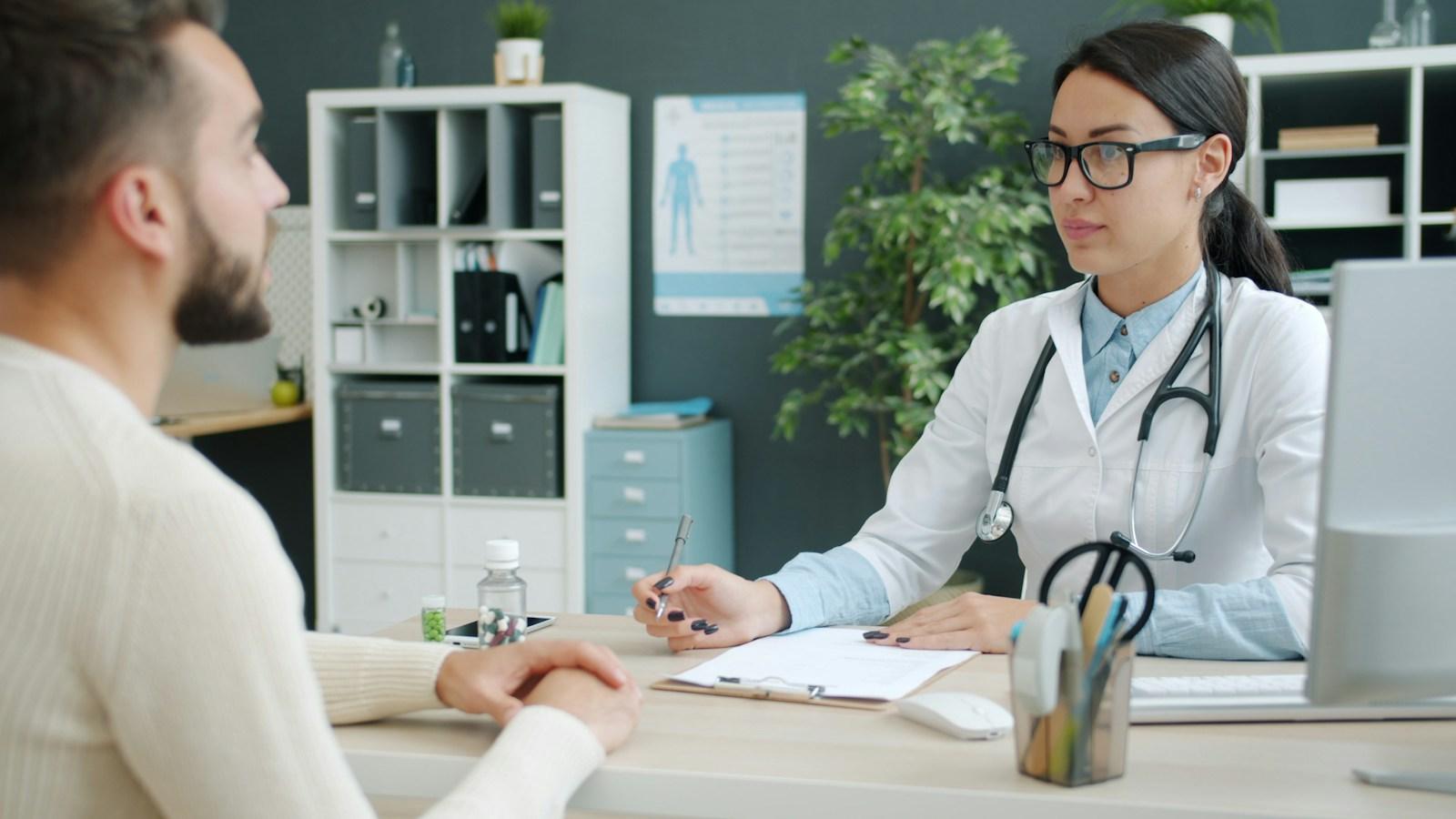 A doctor talking with a patient in a clinic office