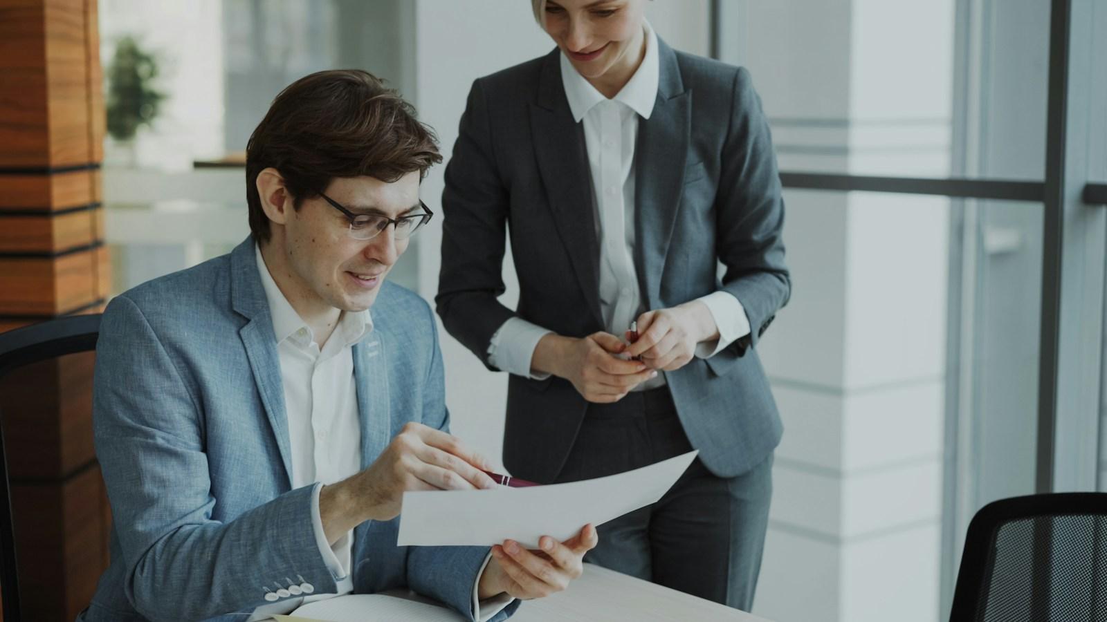 Two consultants reviewing a document together
