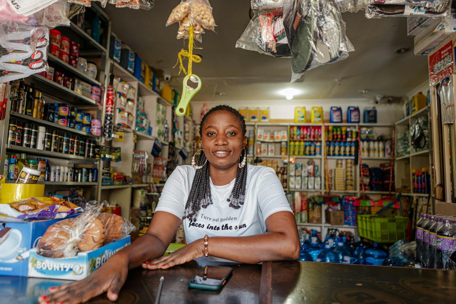 A shop owner at the counter of her store