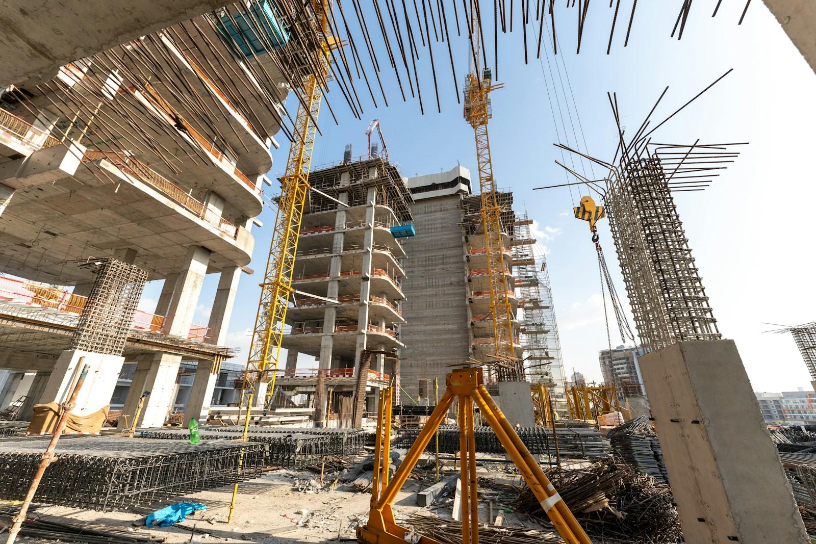 High-rise buildings under construction with cranes