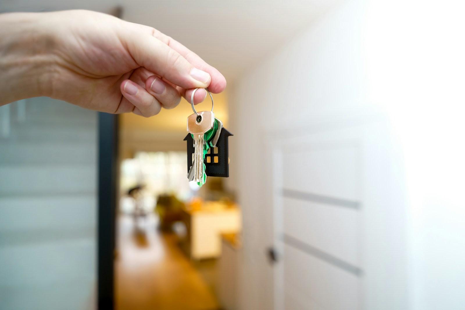 A hand holding the keys to a new apartment